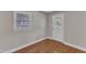 Room with wood floors, natural light from window, and a white door with glass at 1031 Wait Ave, Wake Forest, NC 27587