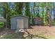 View of two wooden sheds with doors, surrounded by trees and natural landscaping at 1031 Wait Ave, Wake Forest, NC 27587