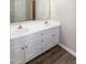 Bathroom featuring a double sink vanity with modern fixtures and wood-look flooring at 104 Eddy Ct, Benson, NC 27504