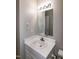 Bathroom features a vanity with sink, and a large mirror with lighting at 104 Eddy Ct, Benson, NC 27504