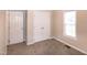 Bedroom with a window, closet, neutral walls, and carpet flooring at 104 Eddy Ct, Benson, NC 27504