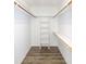 Walk-in closet with custom shelving and racks for optimal storage and organization at 104 Eddy Ct, Benson, NC 27504