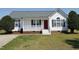 Charming single-story home featuring a welcoming front porch, red door, and well-maintained lawn at 104 Eddy Ct, Benson, NC 27504