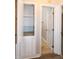 Hallway view featuring a linen closet, wood-look flooring, and neutral paint at 104 Eddy Ct, Benson, NC 27504