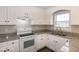 Bright kitchen features granite countertops, white cabinets, and stainless steel appliances at 104 Eddy Ct, Benson, NC 27504