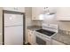 Well-lit kitchen featuring white appliances and granite countertops at 104 Eddy Ct, Benson, NC 27504