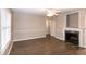Spacious living room with a cozy fireplace, window and neutral tones, perfect for gatherings at 104 Eddy Ct, Benson, NC 27504