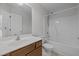 Full bathroom with a single vanity, toilet, and shower-tub combo with white shower curtain, providing a functional space at 11425 Shadow Elms Ln, Raleigh, NC 27614
