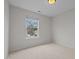 Cozy bedroom featuring neutral walls, carpet, and a bright window, creating a serene and inviting atmosphere at 11425 Shadow Elms Ln, Raleigh, NC 27614