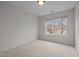 Comfortable bedroom featuring neutral walls, carpet, and a bright window, creating a serene and inviting atmosphere at 11425 Shadow Elms Ln, Raleigh, NC 27614