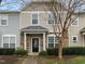 Charming townhome with stone accents, neutral siding, and a well-maintained front yard with mature landscaping at 11425 Shadow Elms Ln, Raleigh, NC 27614