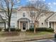Inviting townhome with stone accents and a well-manicured lawn and mature landscaping at 11425 Shadow Elms Ln, Raleigh, NC 27614