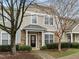 Charming townhome with a stone and siding facade, complemented by mature trees at 11425 Shadow Elms Ln, Raleigh, NC 27614