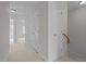 Hallway leading to carpeted rooms with white doors and trim, offering a clean and bright transition space at 11425 Shadow Elms Ln, Raleigh, NC 27614