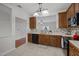Well-equipped kitchen showcasing wood cabinetry, tile backsplash, and black appliances for a functional cooking space at 11425 Shadow Elms Ln, Raleigh, NC 27614