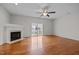 Bright living room with fireplace, hardwood floors, and sliding glass doors to the backyard at 11425 Shadow Elms Ln, Raleigh, NC 27614