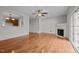 Open-concept space featuring a cozy fireplace, hardwood floors, and a view into the kitchen at 11425 Shadow Elms Ln, Raleigh, NC 27614