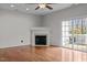 Cozy living room with fireplace, hardwood floors, and bright sliding glass doors to the backyard at 11425 Shadow Elms Ln, Raleigh, NC 27614