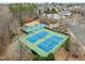 Overhead view of well-maintained tennis courts and the community playground at 11425 Shadow Elms Ln, Raleigh, NC 27614