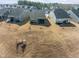 Aerial view of the backyards in a residential neighborhood with freshly installed lawns and modern homes at 1255 White Flint Cir, Durham, NC 27703