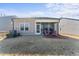 Spacious backyard featuring a screened patio with outdoor seating and a well-maintained lawn at 1255 White Flint Cir, Durham, NC 27703