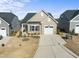 Tan single-Gathering home with a well-manicured lawn, attached garage, and neutral trim at 1255 White Flint Cir, Durham, NC 27703