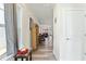Bright hallway with wood-look flooring and a view into a comfortable living room at the end at 1255 White Flint Cir, Durham, NC 27703