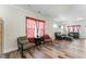 Spacious living room with hardwood floors and large windows with seating in the corners of the room at 1255 White Flint Cir, Durham, NC 27703