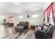 Open-concept living room features hardwood floors and multiple seating areas with views out the windows at 1255 White Flint Cir, Durham, NC 27703