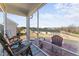 Screened-in patio with brick flooring and lawn view, with a blue decorative rug under the lounge seating at 1255 White Flint Cir, Durham, NC 27703