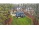 Aerial view of a blue home with a screened in back porch and a big backyard at 130 Willow Bend Dr, Youngsville, NC 27596