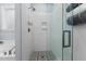 Modern bathroom featuring a tiled shower with glass door and decorative floor tiles at 130 Willow Bend Dr, Youngsville, NC 27596