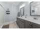 Bathroom with double sink vanity, large mirrors, walk-in shower, and light blue walls at 130 Willow Bend Dr, Youngsville, NC 27596