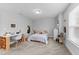 Spacious bedroom featuring a desk and chair, guitars, a dresser, and a cozy bed at 130 Willow Bend Dr, Youngsville, NC 27596