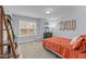 Cozy bedroom with a comfortable bed, a modern lamp, and natural light from a window at 130 Willow Bend Dr, Youngsville, NC 27596