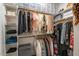 Organized walk-in closet with hanging racks and shelving for optimal storage at 130 Willow Bend Dr, Youngsville, NC 27596