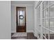 Entryway featuring a wooden door with decorative glass and a patterned welcome mat on dark floors at 130 Willow Bend Dr, Youngsville, NC 27596