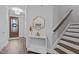 Inviting entryway featuring a wooden door, a stylish mirror, and a staircase with wooden treads at 130 Willow Bend Dr, Youngsville, NC 27596