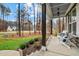 Inviting front porch with comfortable seating and views of the wooded surroundings at 130 Willow Bend Dr, Youngsville, NC 27596