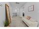 Inviting hallway with carpet, bench with pillows, and a full-length mirror, enhancing the ambiance at 130 Willow Bend Dr, Youngsville, NC 27596