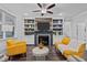 Cozy living room with fireplace, TV, built-in shelving, and stylish decor at 130 Willow Bend Dr, Youngsville, NC 27596