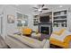 Cozy living room with fireplace, built-ins, and stylish seating with natural lighting from a window at 130 Willow Bend Dr, Youngsville, NC 27596