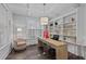 Home office featuring custom built-in bookshelves, modern light fixture, and a large window for natural light at 130 Willow Bend Dr, Youngsville, NC 27596