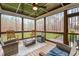 Relaxing screened porch with wooden ceiling, ceiling fan and wicker furniture at 130 Willow Bend Dr, Youngsville, NC 27596