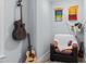 Cozy sitting area with comfortable chair, guitars, and martial arts belts on the wall at 130 Willow Bend Dr, Youngsville, NC 27596