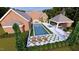 Expansive aerial view showcasing the pool, lounge areas, and lush landscaping at 1612 Hunting Ridge Rd, Raleigh, NC 27615