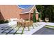 Stunning outdoor dining and lounge area with a pool and lush greenery at 1612 Hunting Ridge Rd, Raleigh, NC 27615