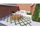 A backyard dining and lounge area featuring stone pavers, and manicured plantings at 1612 Hunting Ridge Rd, Raleigh, NC 27615