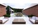 A beautiful backyard oasis with a dining table, lounge chairs, and lush landscaping at 1612 Hunting Ridge Rd, Raleigh, NC 27615