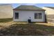 Image of the home's backyard with an air conditioning unit in view. The yard backs up to a fence at 1628 Beacon Village Dr, Raleigh, NC 27604